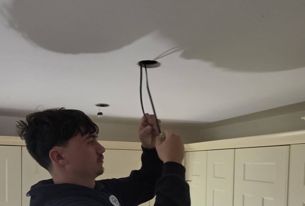 365 Services MK electrician working on kitchen ceiling lighting cables in Bletchley